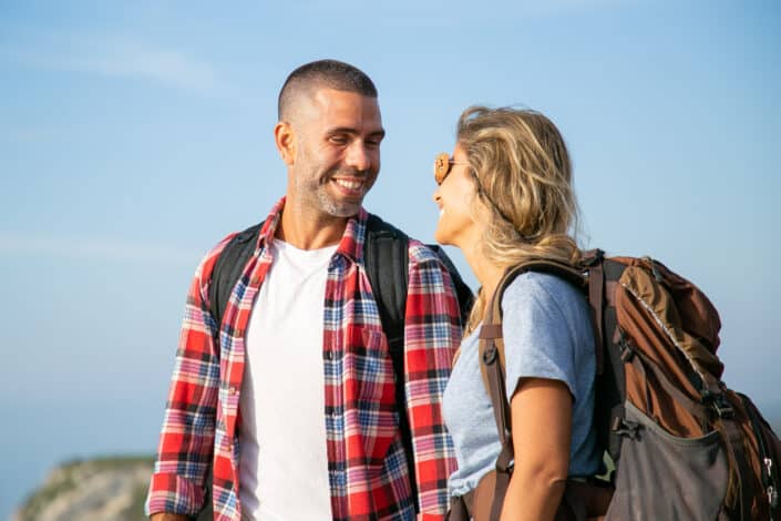 Couple Smiling At Each Other While On A Hike