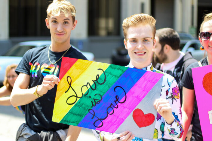People Holding "Love is Love" Poster