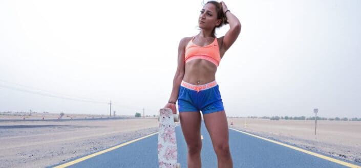 Athletic Woman Carrying a Skateboard
