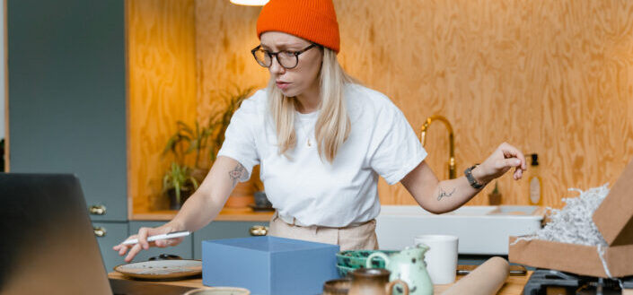 Busy woman wearing eyeglasses and orange bonnet 