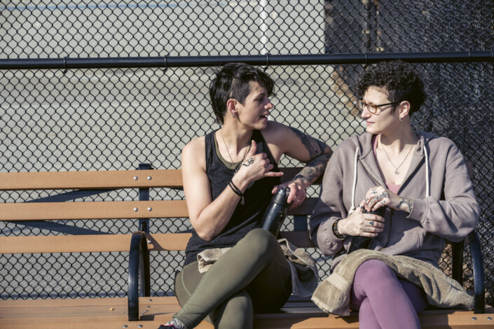 female-friends-chatting-on-bench-stockpack-pexels