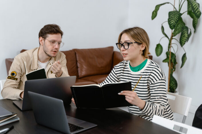 Man and woman discussing in workplace