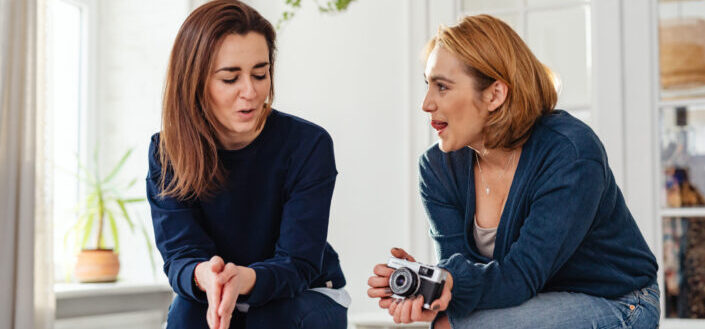 photo-of-woman-holding-a-camera-while-talking-to-her-friend-stockpack-pexels