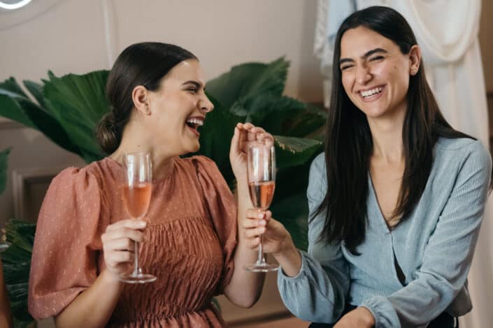 two-women-having-fun-while-drinking-a-rose-wine-stockpack-pexels