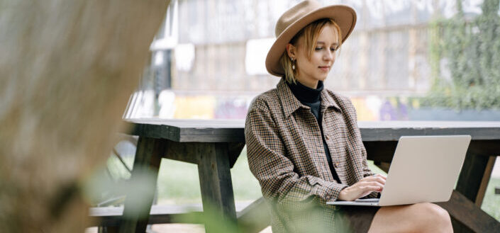 Woman in Plaid Shirt Using a Laptop