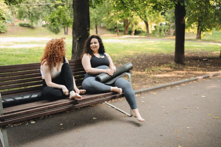 women-talking-while-sitting-on-a-wooden-bench-stockpack-pexels