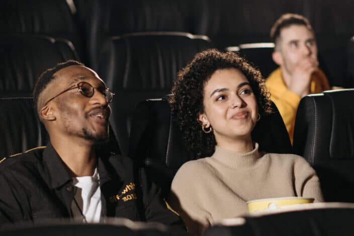 A Smiling Couple Watching a Movie