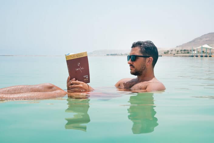 Man Reading a Book While in Beach