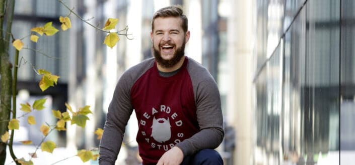 A happy bearded man wearing sweatshirt