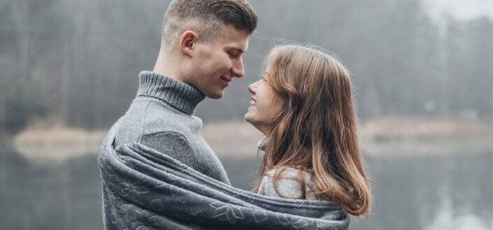 couple standing together wrapped in a blanket