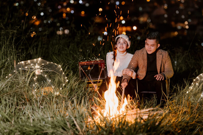 Happy couple near bonfire at night