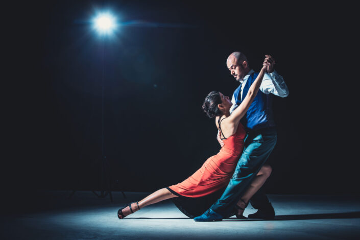man and woman dancing under light