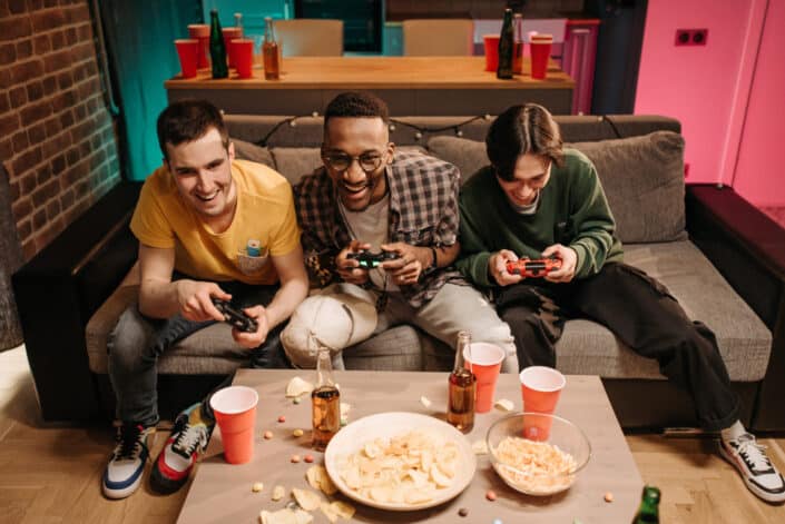 group of men drinking and playing video games