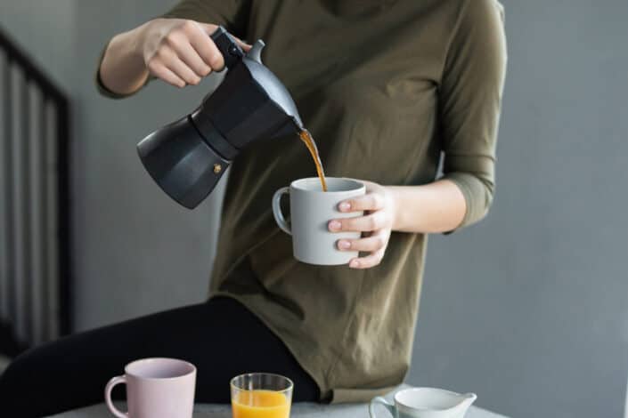 a woman pouring coffee