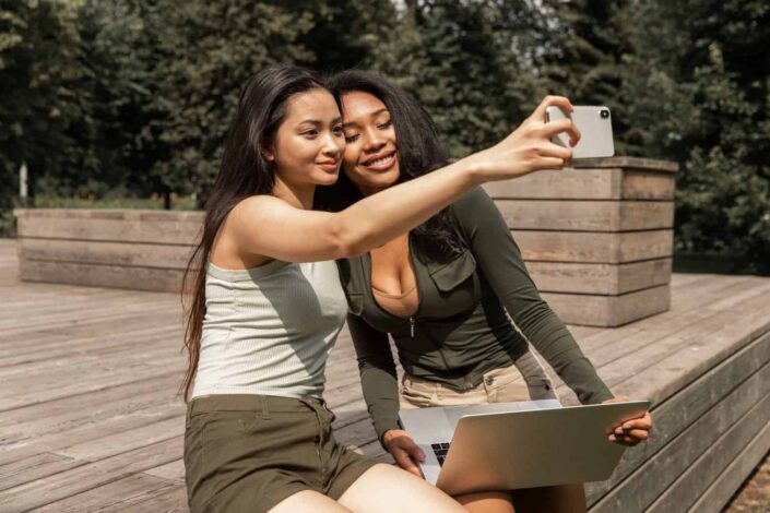 Joyful Young Women Taking a Selfie in the Park