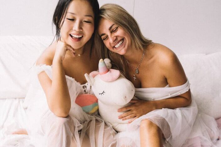 Women Smiling With a Stuffed Toy