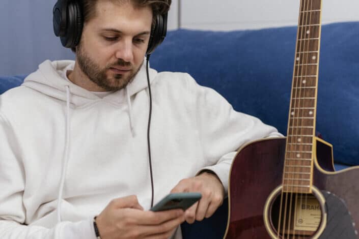 A man in white hoodie sweater wearing a headphones 