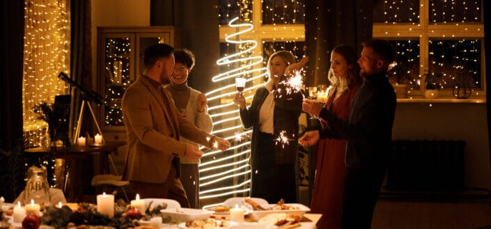 Family Celebrating Christmas While Holding Burning Sparklers