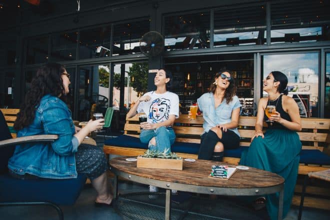 Funny questions to ask friends - Group of ladies sitting on a bench while drinking coffee