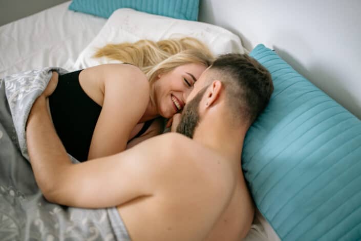 Man embracing woman in bed