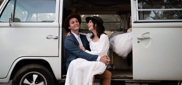couple sitting on their van