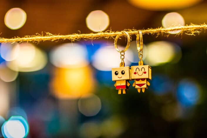 wooden couple keychains hanging on the rope