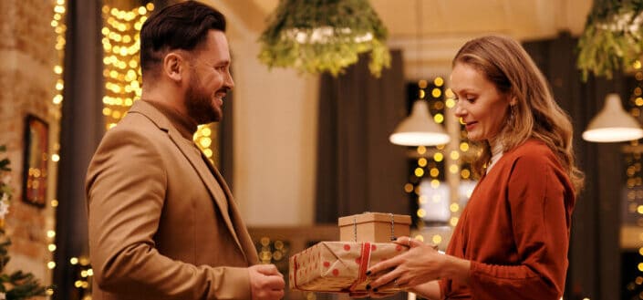 Woman Giving Christmas Presents to Her Husband