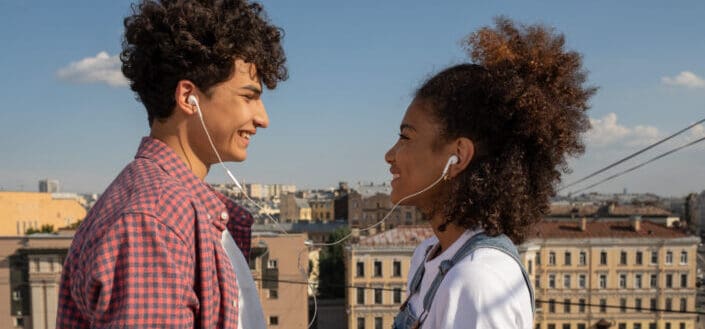 Young couple sharing earphones