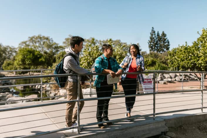 College students standing on a footbridge
