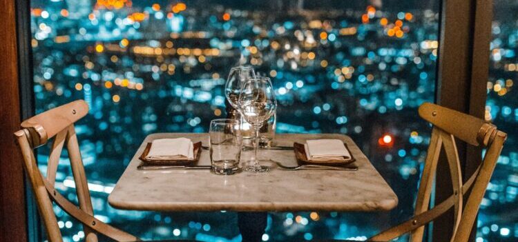 a dinner setup with city light background 