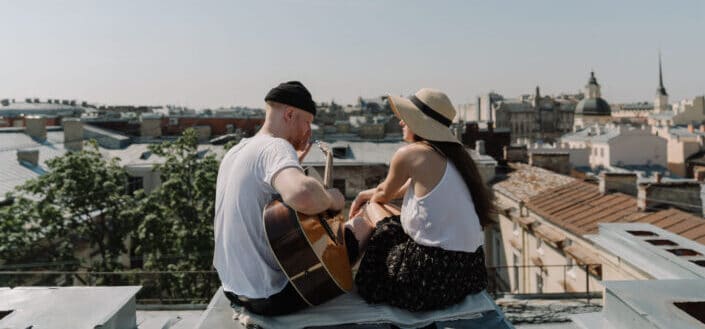Man and woman sitting on rooftop