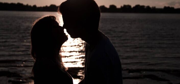 Silhouette of Man and Woman About to Kiss
