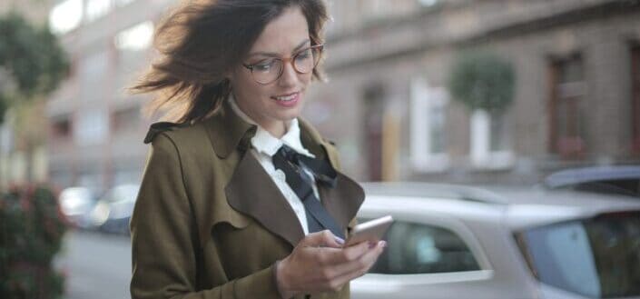 Female using smartphone on street