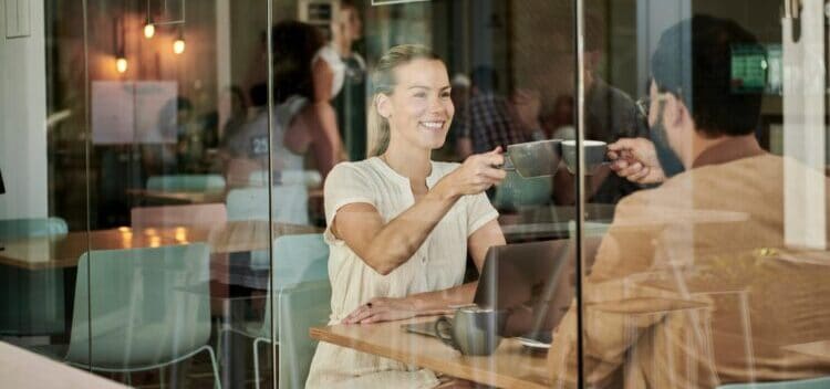 woman in white shirt sitting at coffee shop