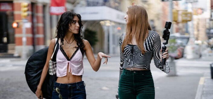 young women talking while walking