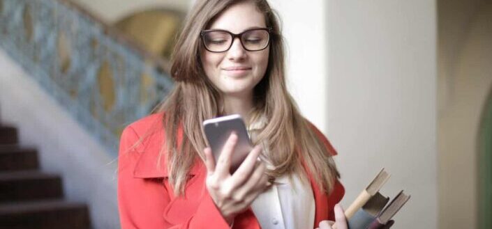 Woman Wearing Red Coat While Holding Phone