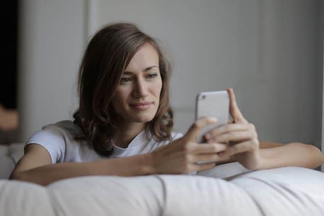 Woman in White Shirt Using Her Phone - Texts to Make Him Think About You