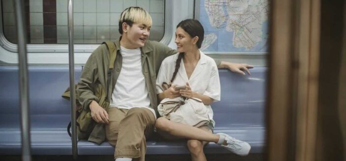 Young Couple Sitting on the Train and Talking