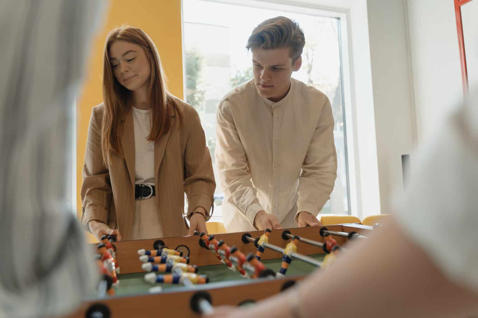 A man and woman playing foosball