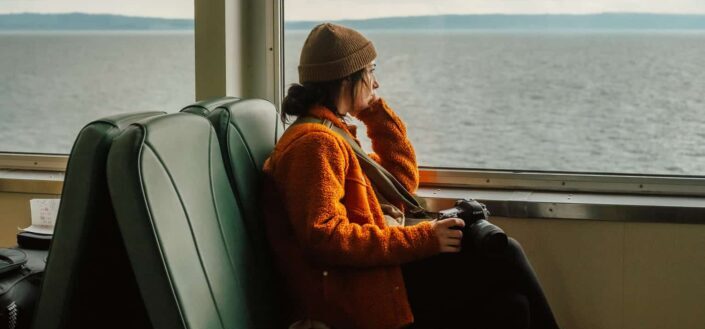 A woman sitting inside the ferryboat