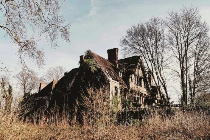 An abandoned house near bare trees