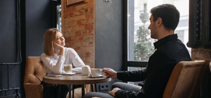 Man and Woman Conversing in Coffee Shop