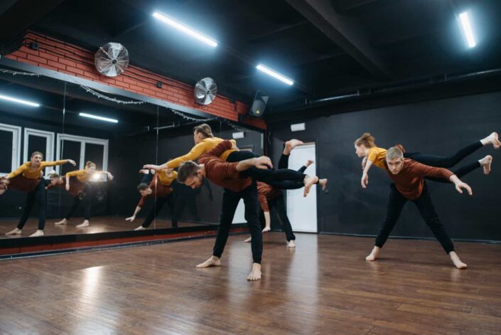 Partners practicing acrobatic dance on a studio