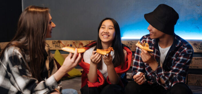 Teens Eating Pizza While Sitting