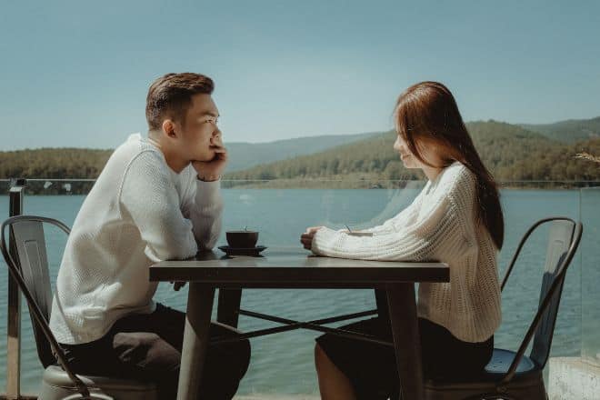 couple having conversation by the sea - How To Make Your Ex Miss You