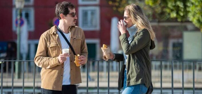 Man and woman eating on the street