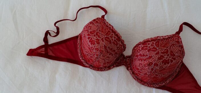Red brassiere on white textile