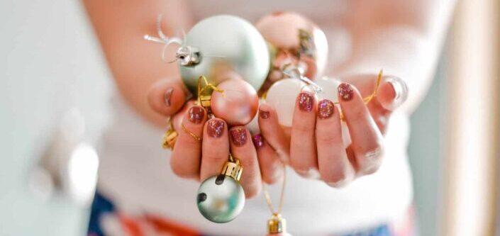 Person holding Christmas baubles